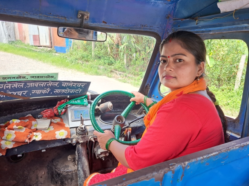 A woman driver sits behind the wheel of an electric bus in Kathmandu, Nepal. The woman received a loan through Aloi, a startup which connects grassroots entrepreneurs to low-interest financing.